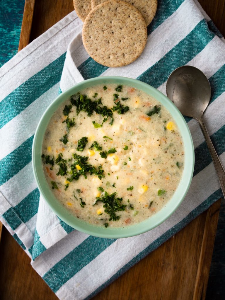 https://goodly.ca/wp-content/uploads/2020/12/Goodly-Purely-Potato-Soup-with-Corn-Kale-Cheddar-Cheese-768x1024-1.jpg